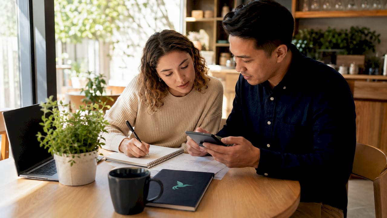 Couple discussing shared financial goals at kitchen table