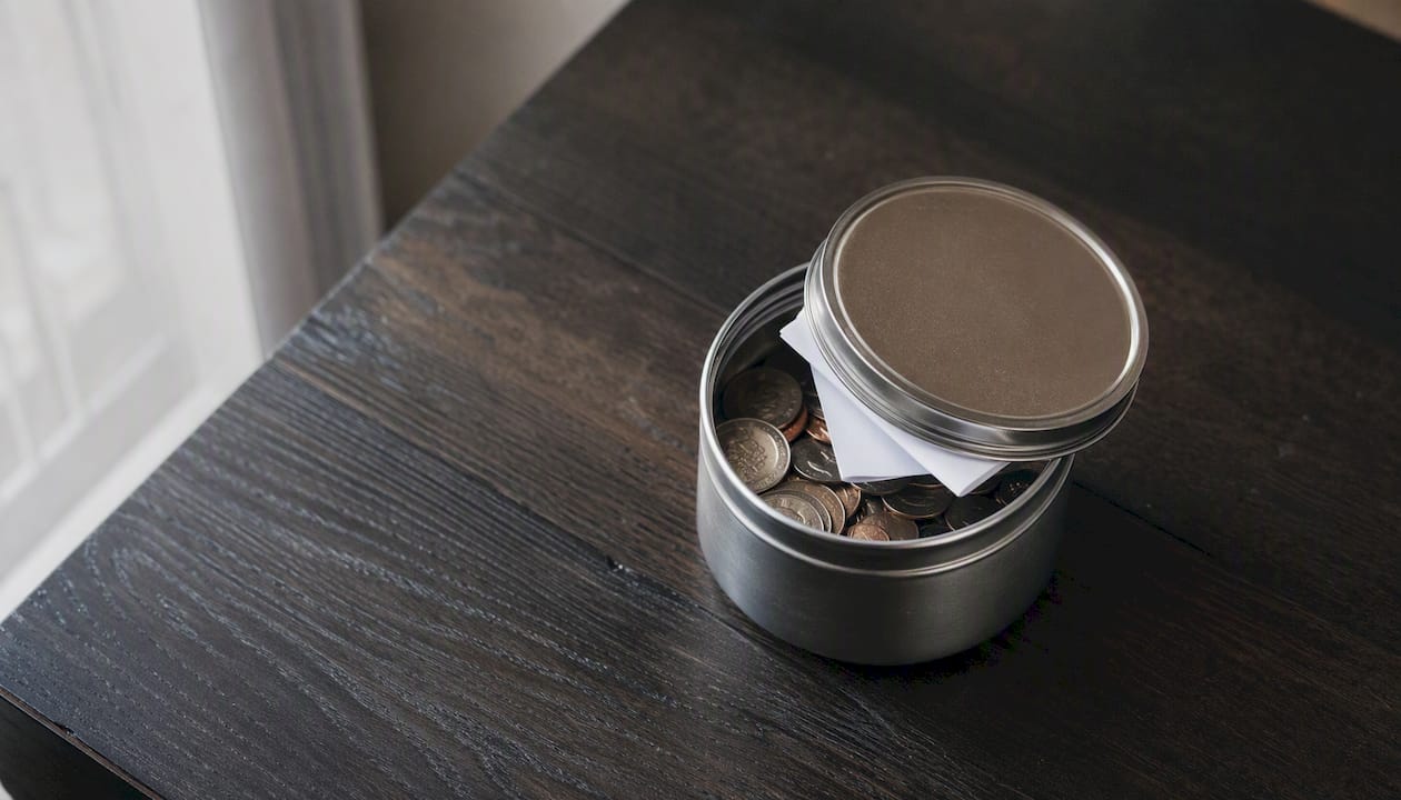 What Is Discretionary Spending, And How Do You Control It? 2 Jar of spare change on table